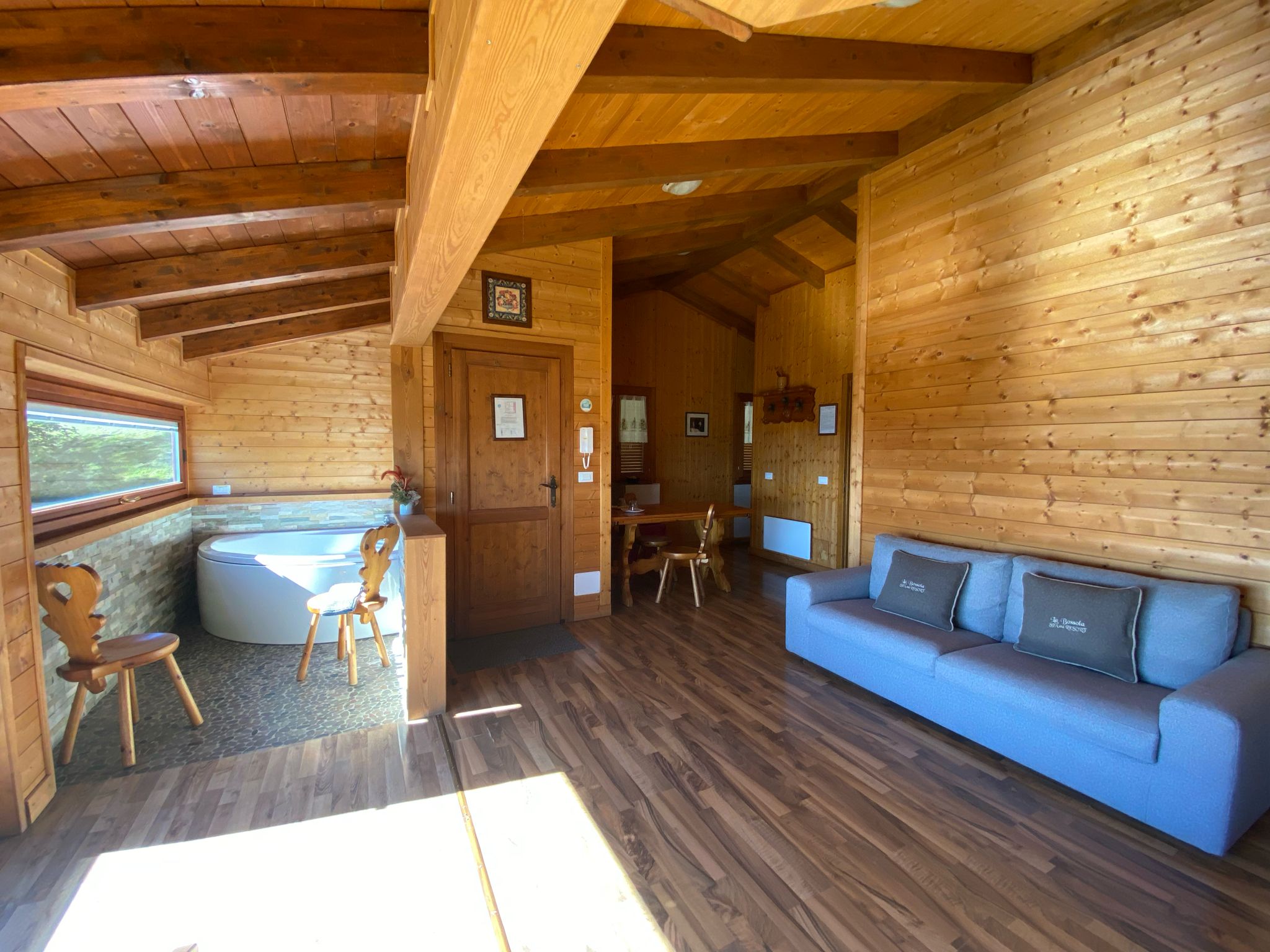 Nella foto, un dettaglio del salotto interno dello Chalet Vacanza Lauretana. Vicino all'ingresso dello Chalet è a tua disposizione la vasca idromassaggio panoramica